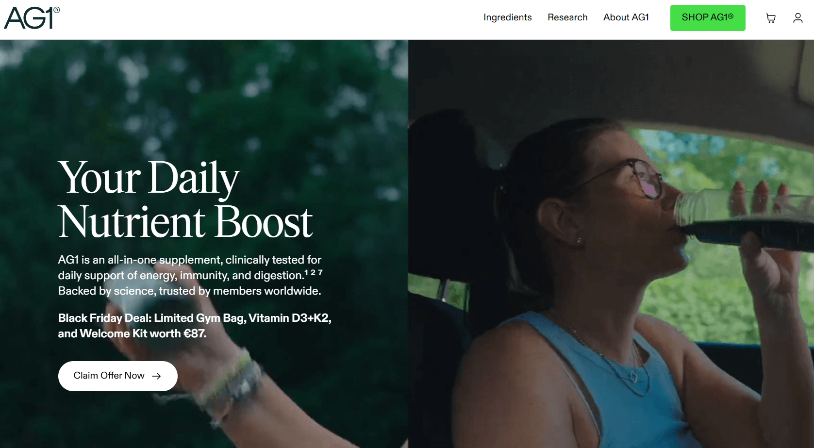 Smiling man at desk with laptop showing growth chart and AG1 supplement package